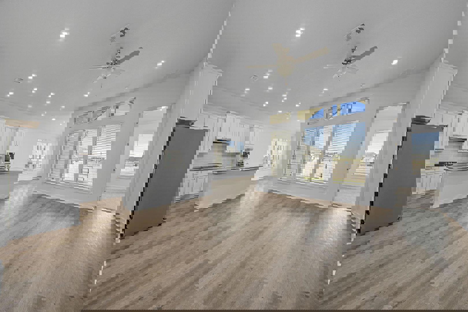 429 Brandywine Road Hutto, TX 78634 - Photo 2 of 28 a large kitchen with cabinets wooden floor and stainless steel appliances