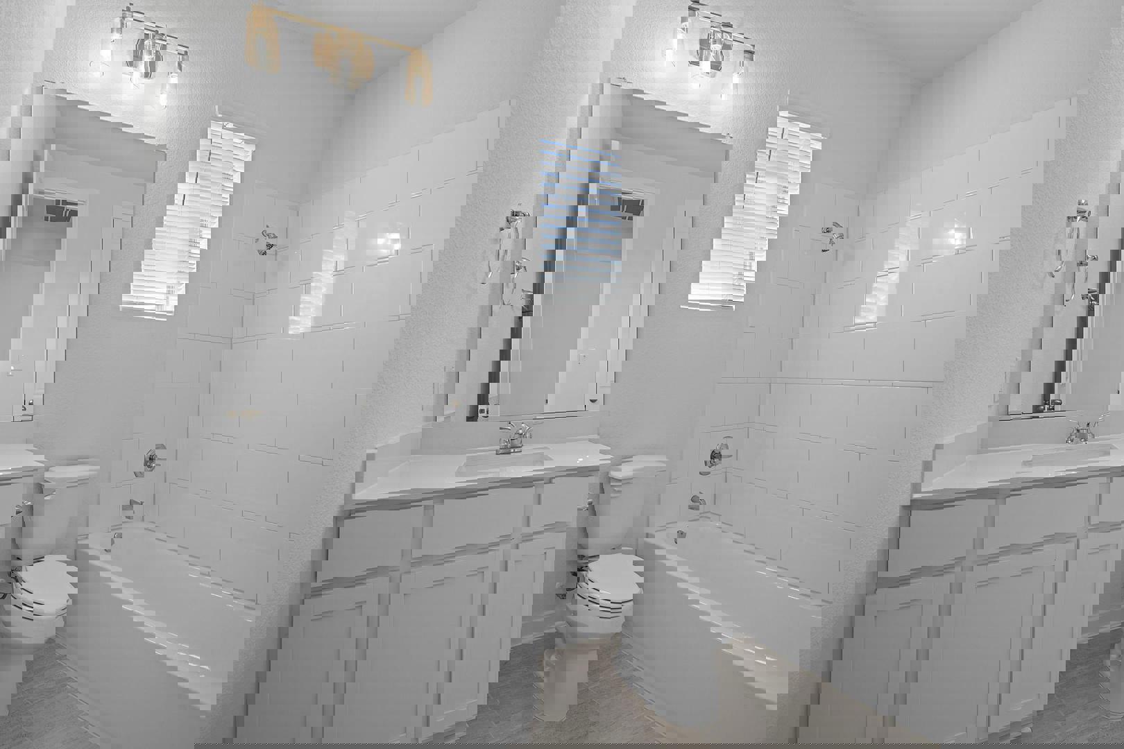 429 Brandywine Road Hutto, TX 78634 - Photo 21 of 28 a bathroom with a toilet a sink a mirror a bathtub and vanity