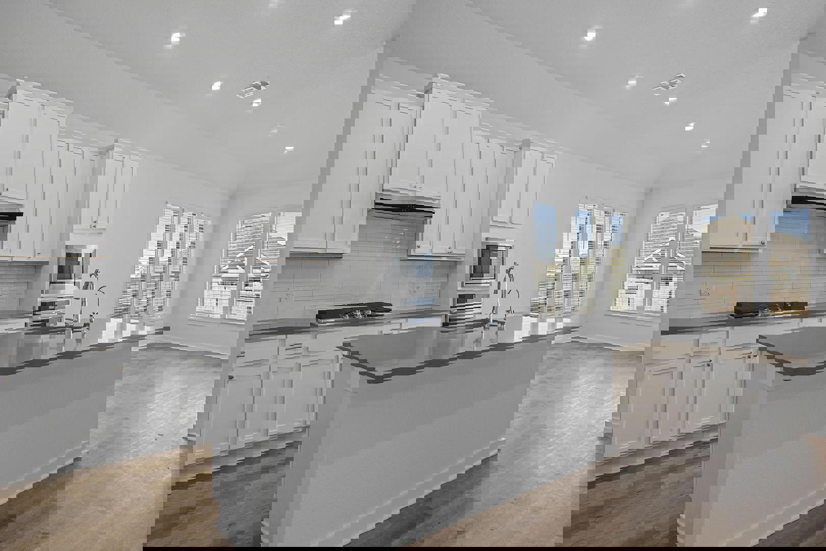 429 Brandywine Road Hutto, TX 78634 - Photo 3 of 28 a kitchen with granite countertop a sink and white cabinets