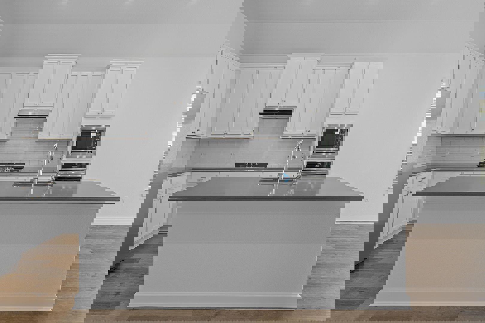 429 Brandywine Road Hutto, TX 78634 - Photo 4 of 28 a kitchen with stainless steel appliances granite countertop a stove a sink and white cabinets