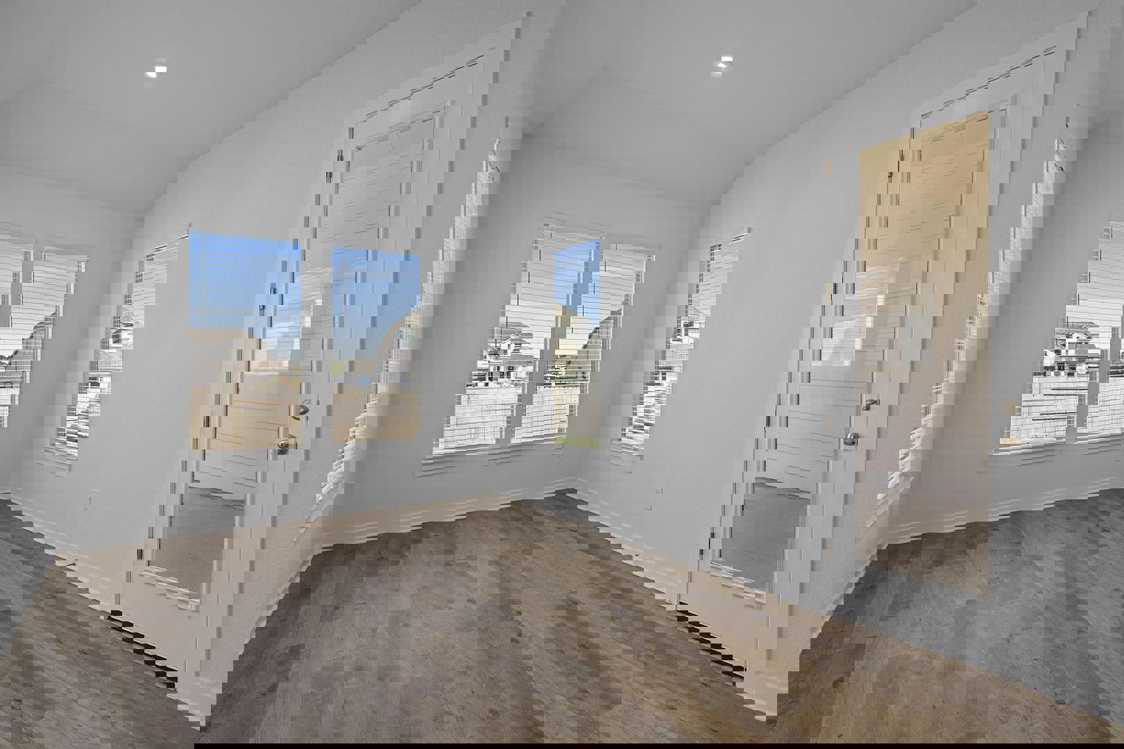 429 Brandywine Road Hutto, TX 78634 - Photo 7 of 28 an empty room with wooden floor and windows