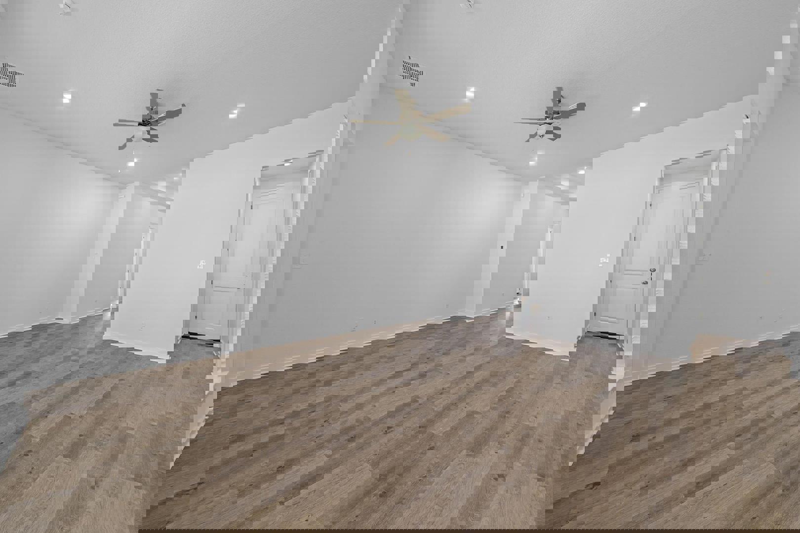 429 Brandywine Road Hutto, TX 78634 - Photo 10 of 28 an empty room with wooden floor ceiling fan and window