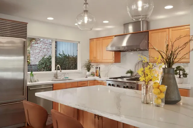 a kitchen with a sink and a large window