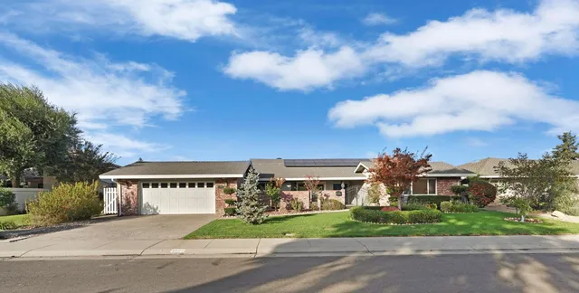 a front view of house with yard and green space