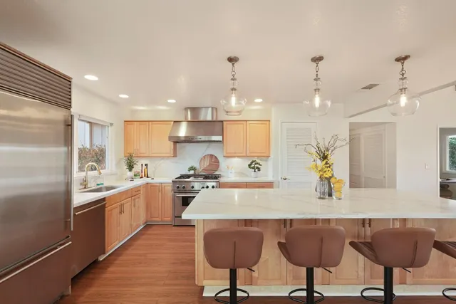 a kitchen that has a sink and a stove in it