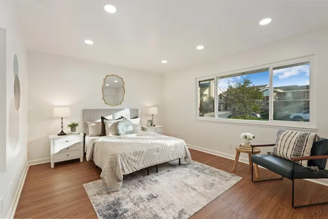 a bedroom with a bed and wooden floor