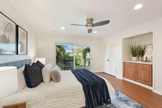 a view of a house with couches and table