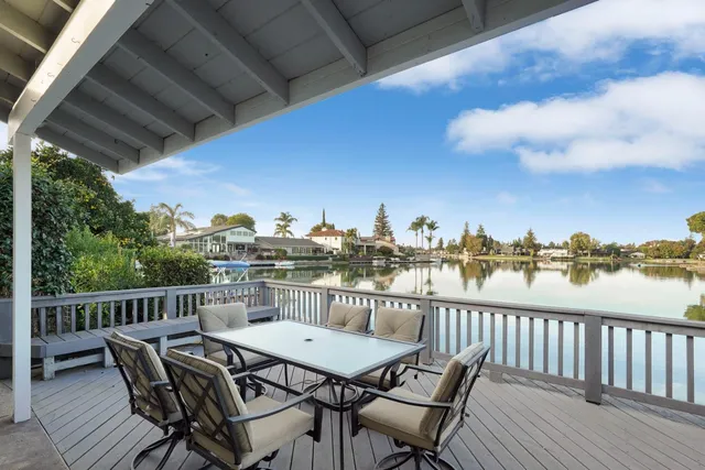 a view of a patio with table and chairs and potted plants
