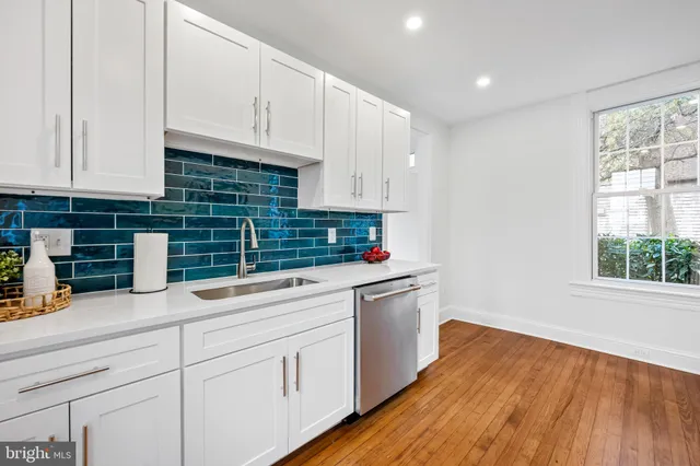 a kitchen with sink and cabinets