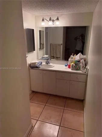 a bathroom with a sink and mirror