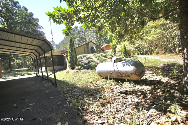 a backyard of a house with table and chairs