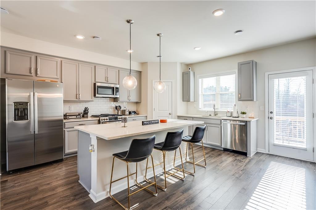 1634 Halbrook Place Southwest Marietta, GA 30008 - Photo 11 of 34 a kitchen with a sink a counter top space stainless steel appliances and cabinets