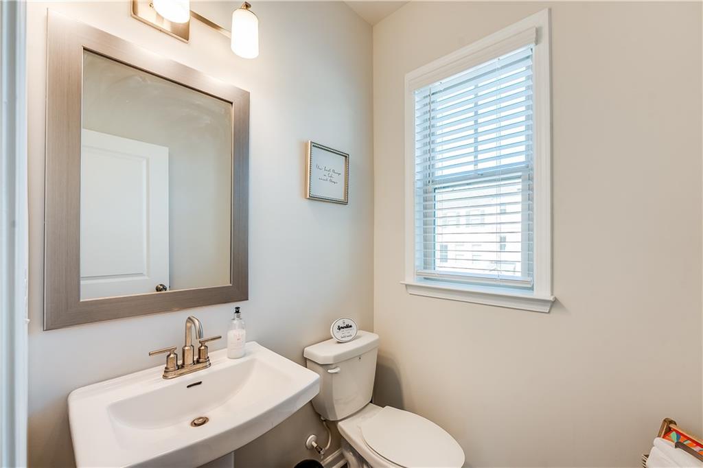 1634 Halbrook Place Southwest Marietta, GA 30008 - Photo 12 of 34 a bathroom with a toilet sink and mirror