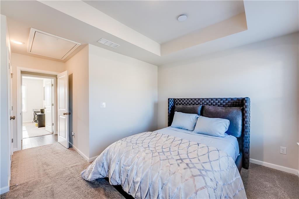 1634 Halbrook Place Southwest Marietta, GA 30008 - Photo 16 of 34 a bedroom with a bed and a mirror