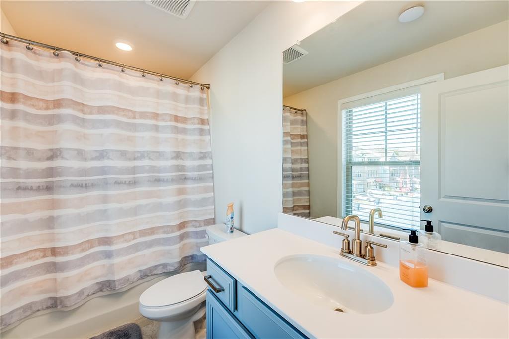 1634 Halbrook Place Southwest Marietta, GA 30008 - Photo 18 of 34 a bathroom with a sink a toilet and tub