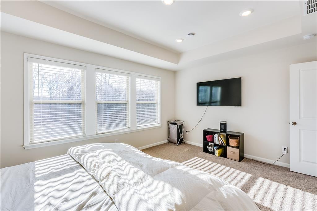 1634 Halbrook Place Southwest Marietta, GA 30008 - Photo 20 of 34 a bedroom with a bed and a flat screen tv