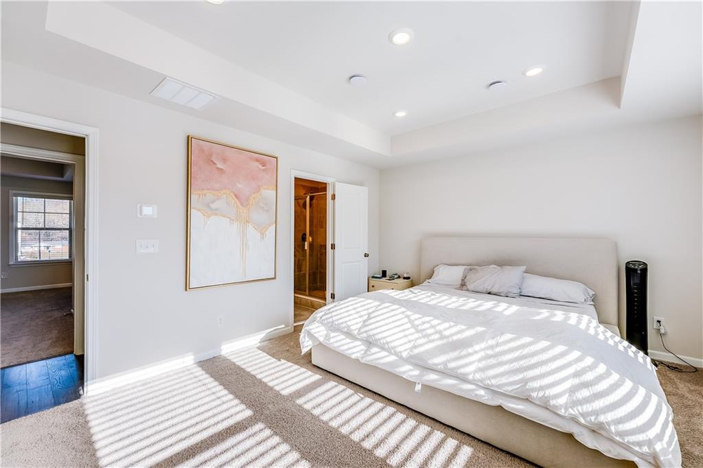 1634 Halbrook Place Southwest Marietta, GA 30008 - Photo 21 of 34 a bedroom with a large bed and a chandelier