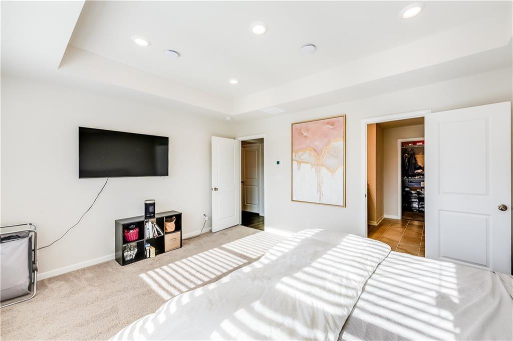 1634 Halbrook Place Southwest Marietta, GA 30008 - Photo 22 of 34 a bedroom with a bed and a flat screen tv