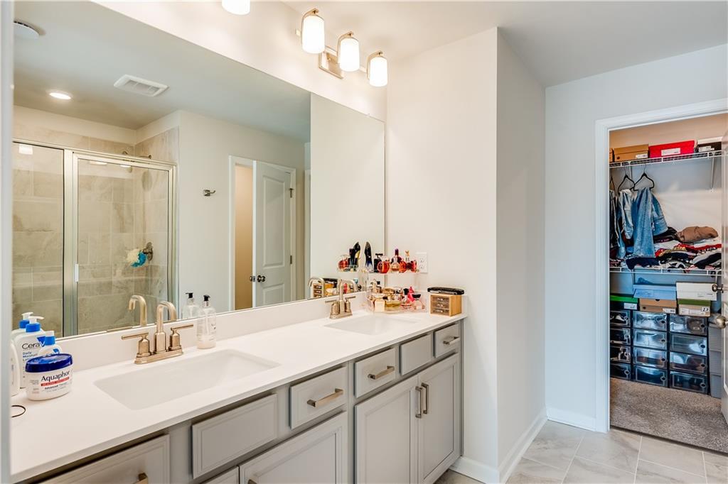 1634 Halbrook Place Southwest Marietta, GA 30008 - Photo 24 of 34 a bathroom with a sink double vanity and a mirror