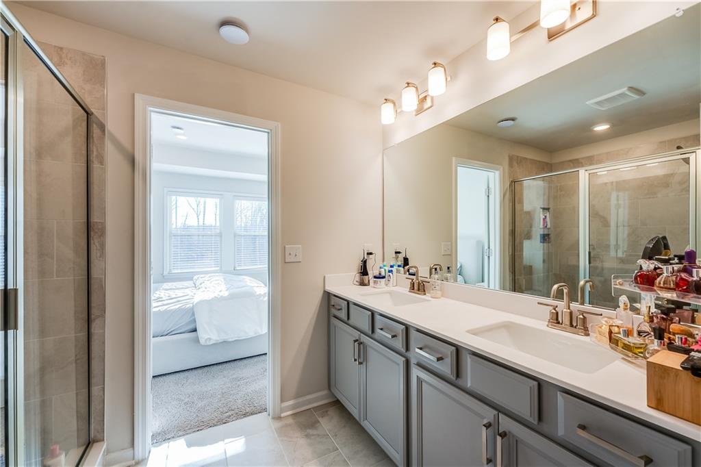 1634 Halbrook Place Southwest Marietta, GA 30008 - Photo 25 of 34 a bathroom with a sink double vanity and a mirror