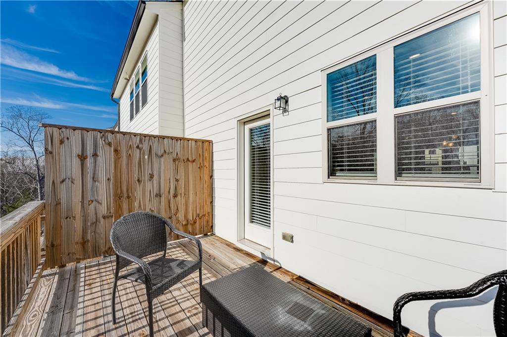 1634 Halbrook Place Southwest Marietta, GA 30008 - Photo 32 of 34 a backyard of a house with barbeque grill and glass windows