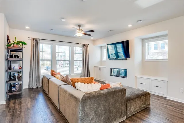 a large kitchen with kitchen island a stove a sink a dining table and chairs with wooden floor