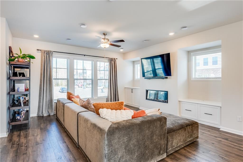 1634 Halbrook Place Southwest Marietta, GA 30008 - Photo 4 of 34 a room with a bed furniture and a flat screen tv