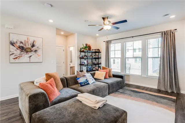 a living room with furniture and a book shelf