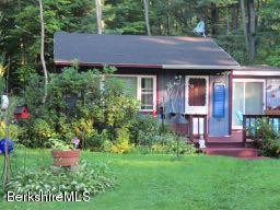 81 Peterson Road Becket, MA 01223 - Photo 2 of 24 a view of a house with a garden and plants
