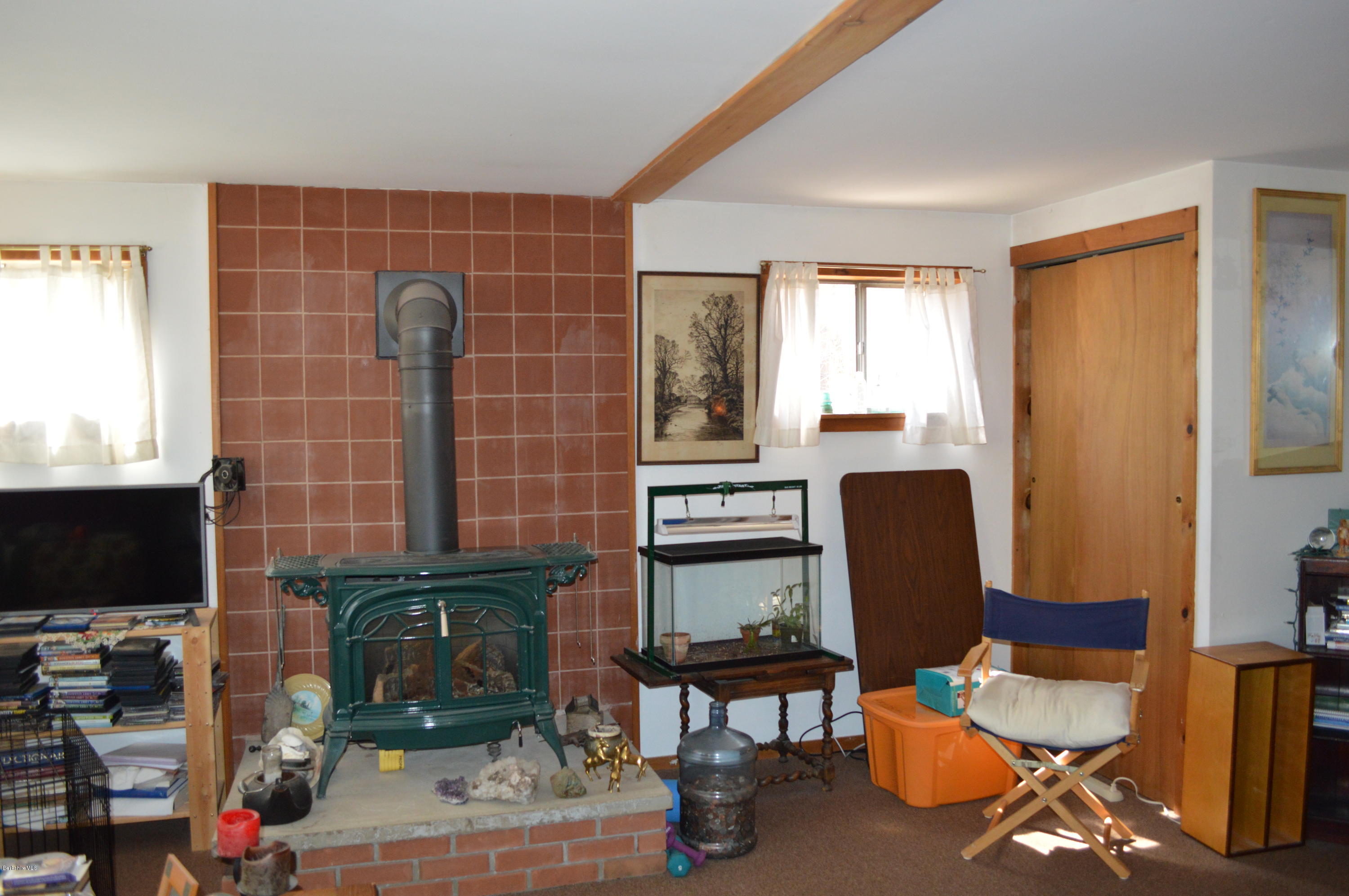 81 Peterson Road Becket, MA 01223 - Photo 16 of 24 a work room with furniture a flat screen tv and large window