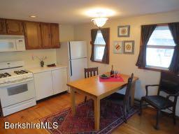 81 Peterson Road Becket, MA 01223 - Photo 3 of 24 a room with kitchen island a stove a sink and a refrigerator