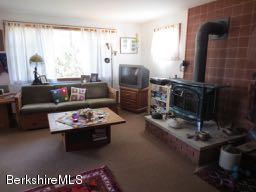 81 Peterson Road Becket, MA 01223 - Photo 24 of 24 a living room with furniture and a fireplace