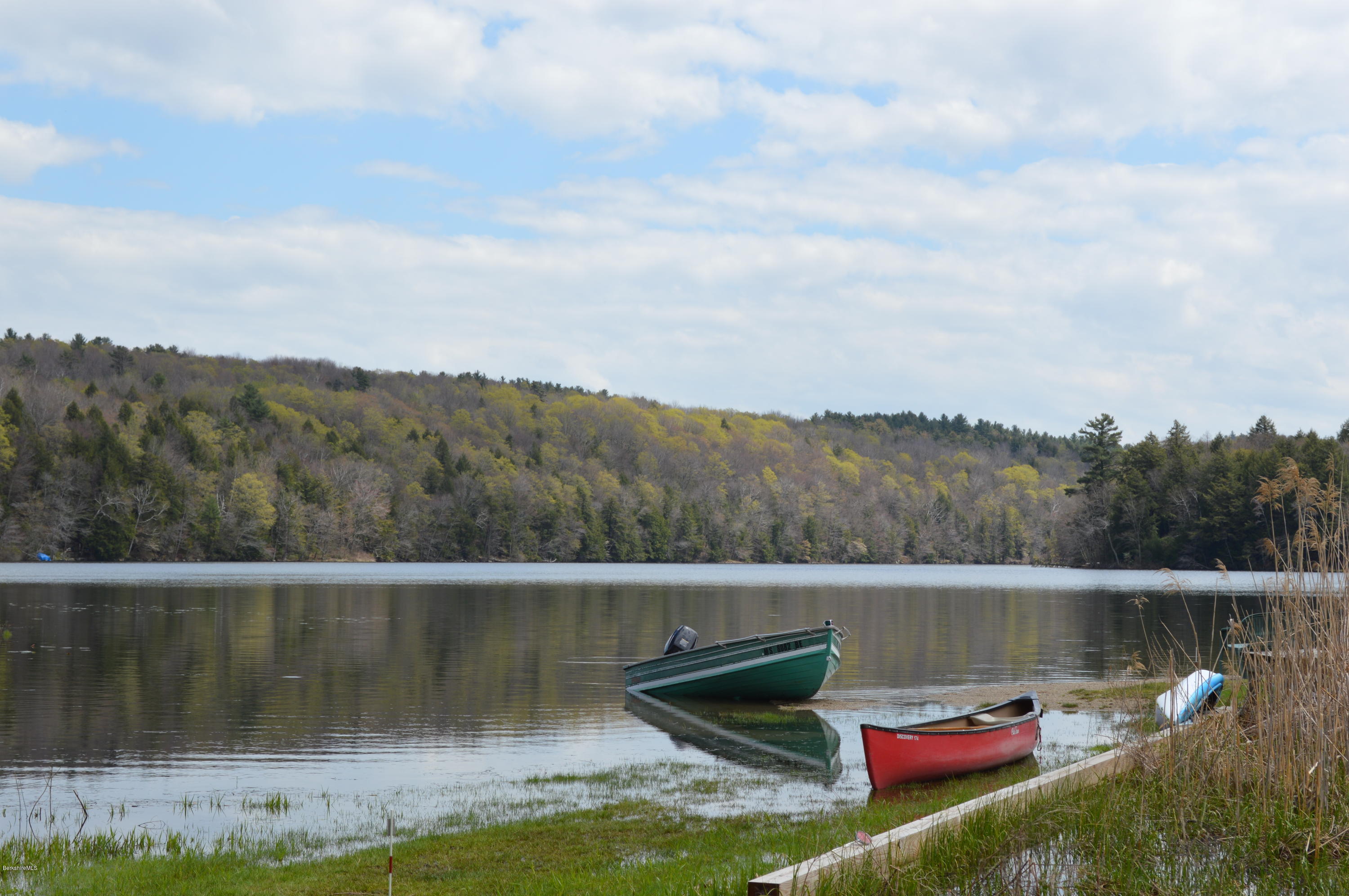 81 Peterson Road Becket, MA 01223 - Photo 4 of 24 a view of a lake with a mountain in the background