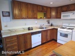 81 Peterson Road Becket, MA 01223 - Photo 7 of 24 a kitchen with a sink stove and cabinets
