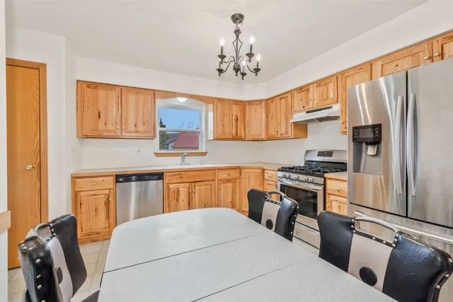 a kitchen with stainless steel appliances granite countertop a refrigerator sink and cabinets