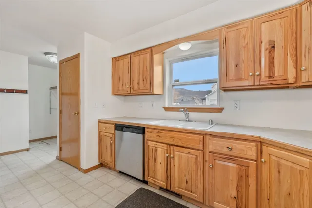 a kitchen with granite countertop white cabinets and sink
