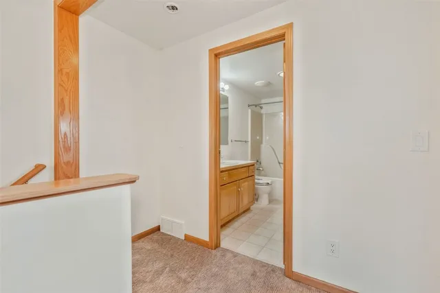 a view of a bathroom from a hallway