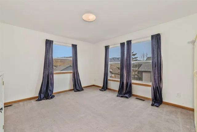 a view of an empty room with closet area