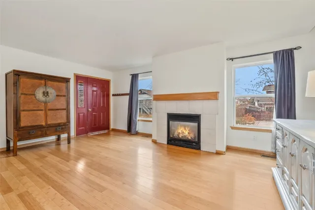 a view of an empty room with furniture and a fireplace