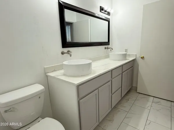 a bathroom with a shower and a sink