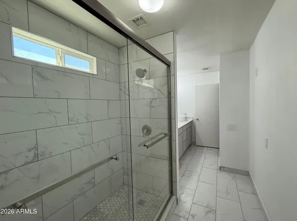 a bathroom with a glass door shower