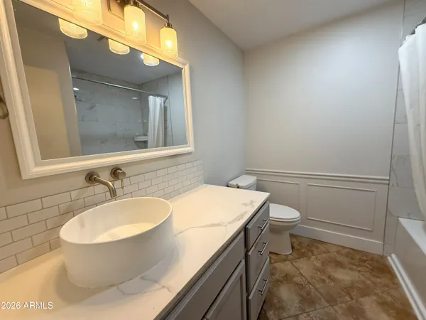 a bathroom with a tub and a sink