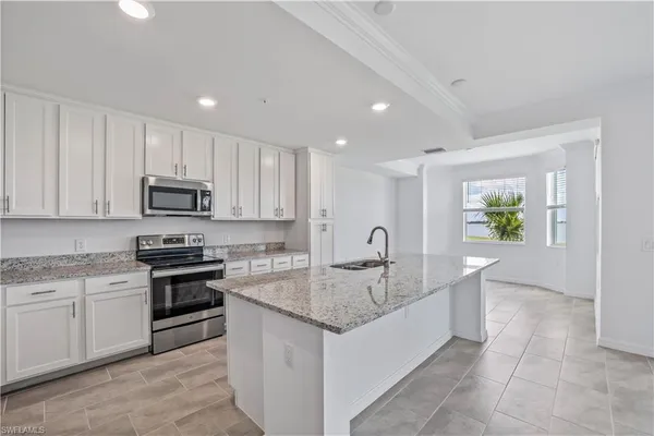 a bathroom with a granite countertop sink a toilet and bathtub