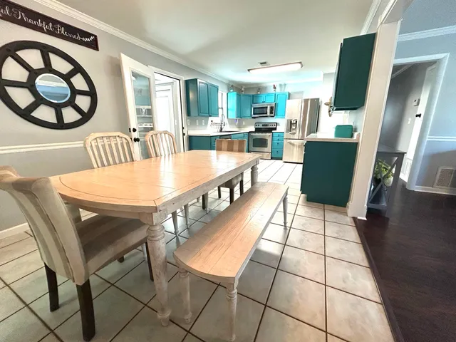 a dining room with furniture and a floor to ceiling window