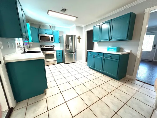 a kitchen with stainless steel appliances a refrigerator sink and cabinets