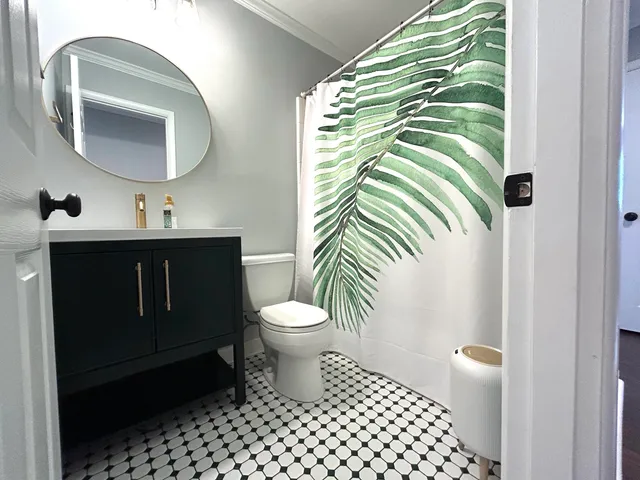 a bathroom with a toilet a sink and mirror