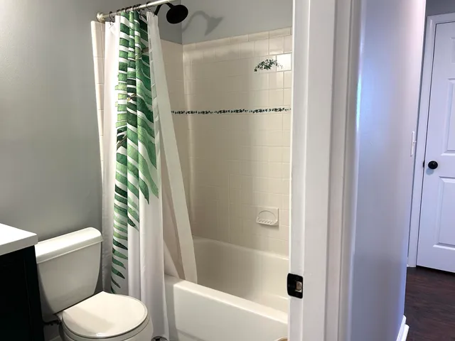 a bathroom with a toilet and a shower