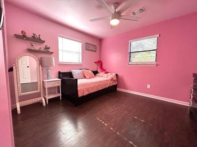 a spacious bedroom with a bed and a dresser