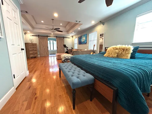 a living room with furniture and a wooden floor