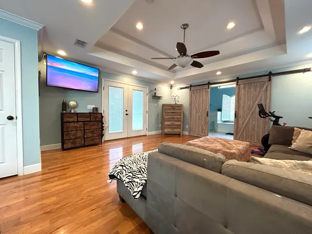 a living room with furniture and a wooden floor